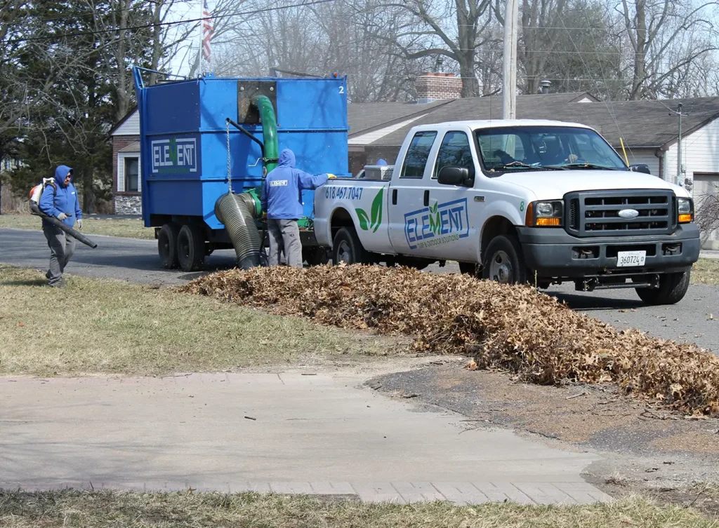 Element Turf & Outdoor Solutions - vacuuming up leaves and debris on the curb